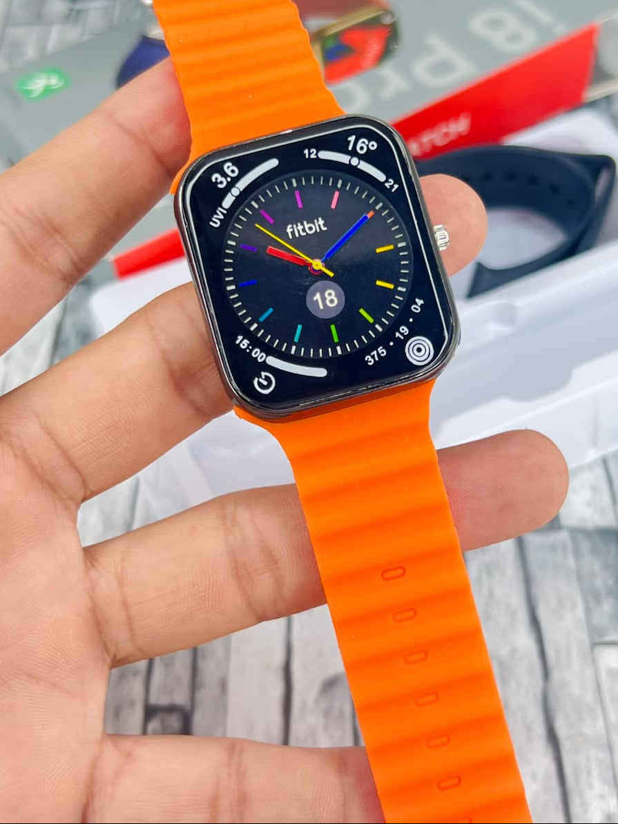 Fitbit smartwatch with orange band held by a hand, blurred background