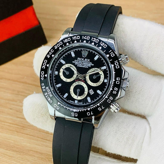 Luxury watch with black strap on a wooden surface