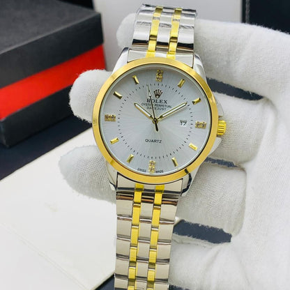 Rolex watch with gold and silver band held by a gloved hand, with a blurred background.