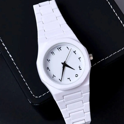 White wristwatch with a black face on a dark background