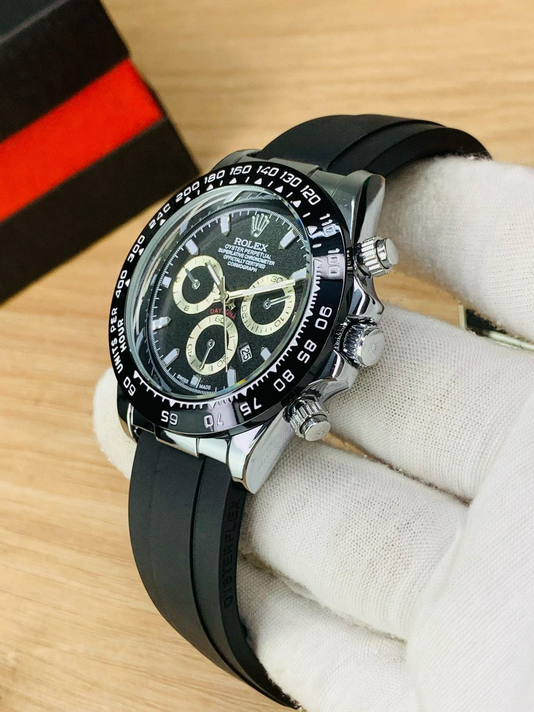 Luxury watch with black strap on a white cloth background